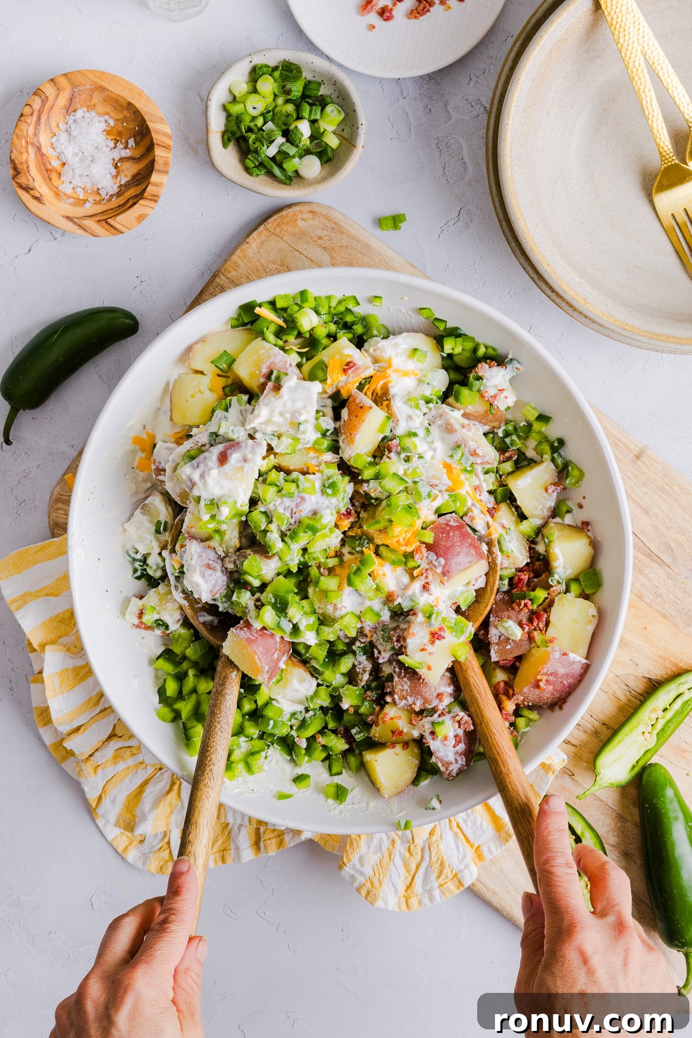 Creamy Jalapeño Popper Potato Salad with Bacon and Cheddar 6 Jalapeño popper potato salad being mixed in a large bowl.