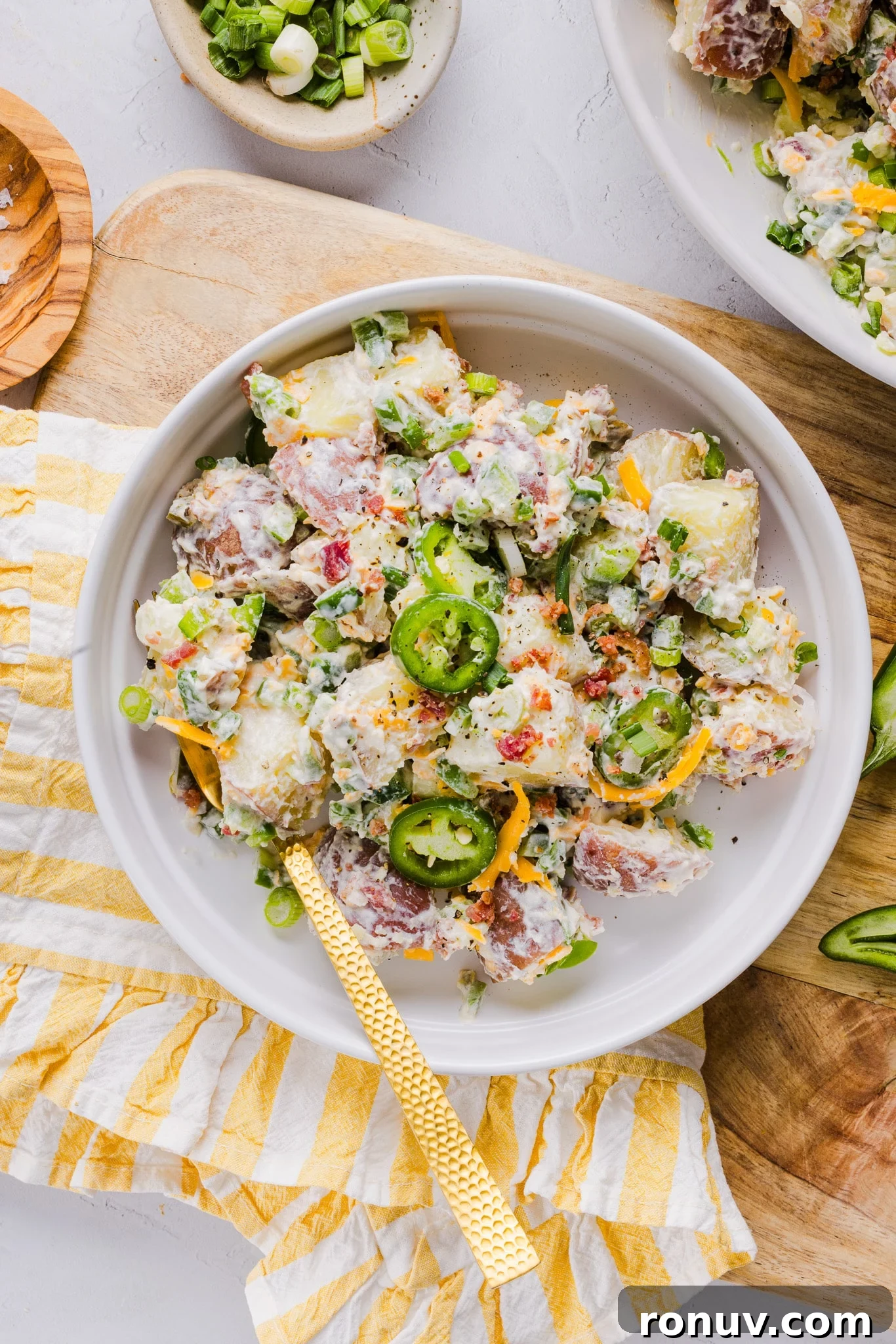 Creamy Jalapeño Popper Potato Salad with Bacon and Cheddar 8 Jalapeño popper potato salad on a plate with a fork.