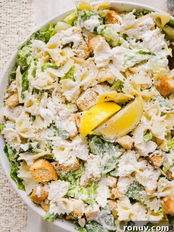 Creamy Jalapeño Popper Potato Salad with Bacon and Cheddar 10 Chicken caesar pasta salad in a large bowl garnished with lemon.