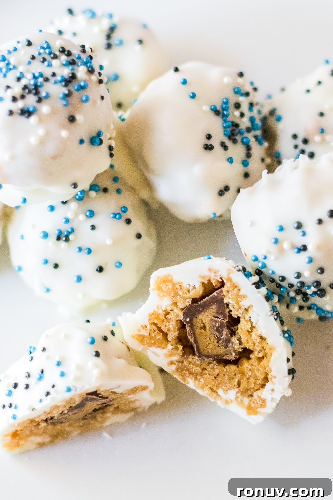 No-Bake Peanut Butter Snowballs Recipe 2 A bite shot of a peanut butter snowball showing the mini reese's cup in the middle.