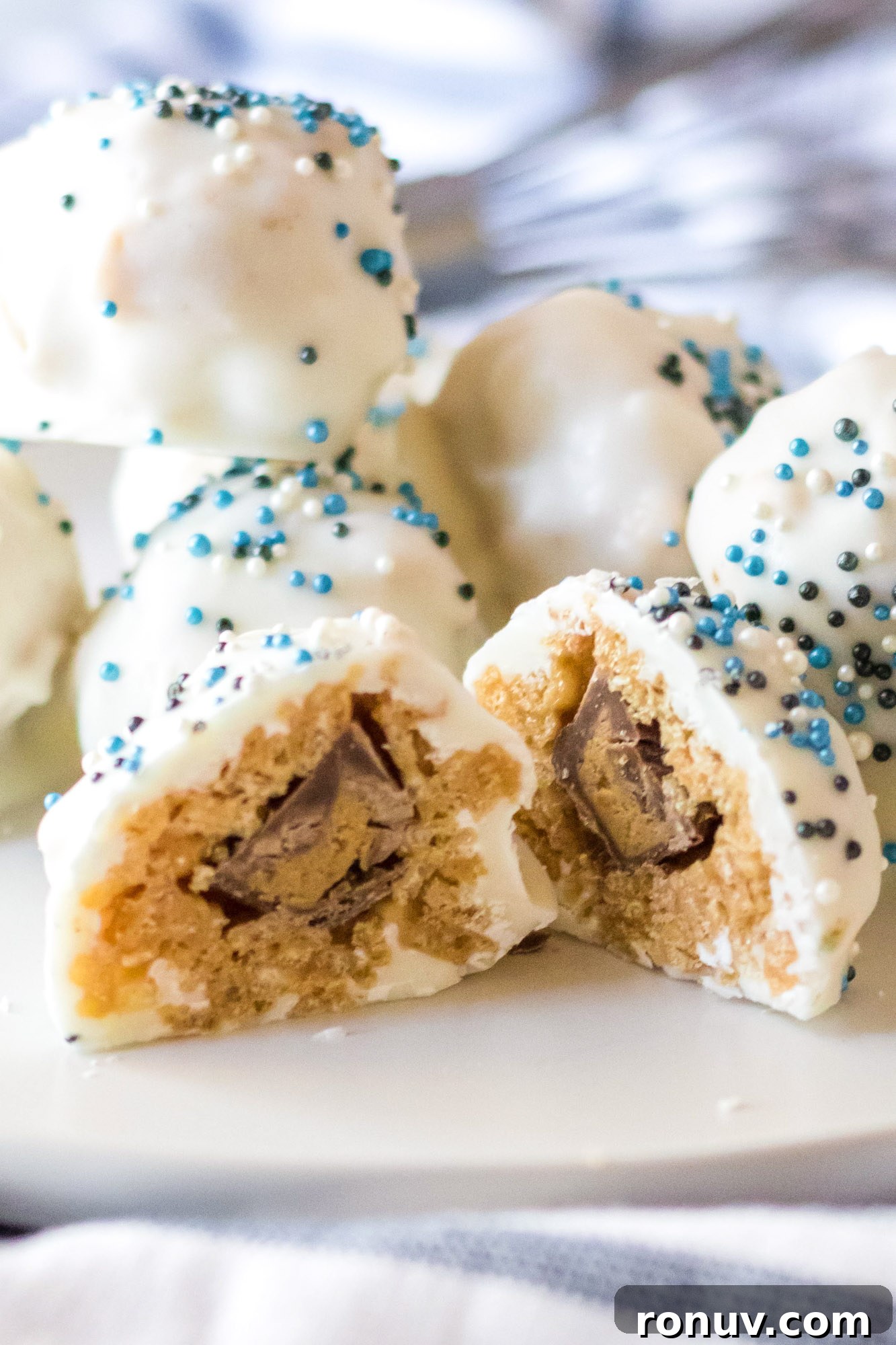 No-Bake Peanut Butter Snowballs Recipe 3 Peanut Butter Snowballs decorated with festive sprinkles.