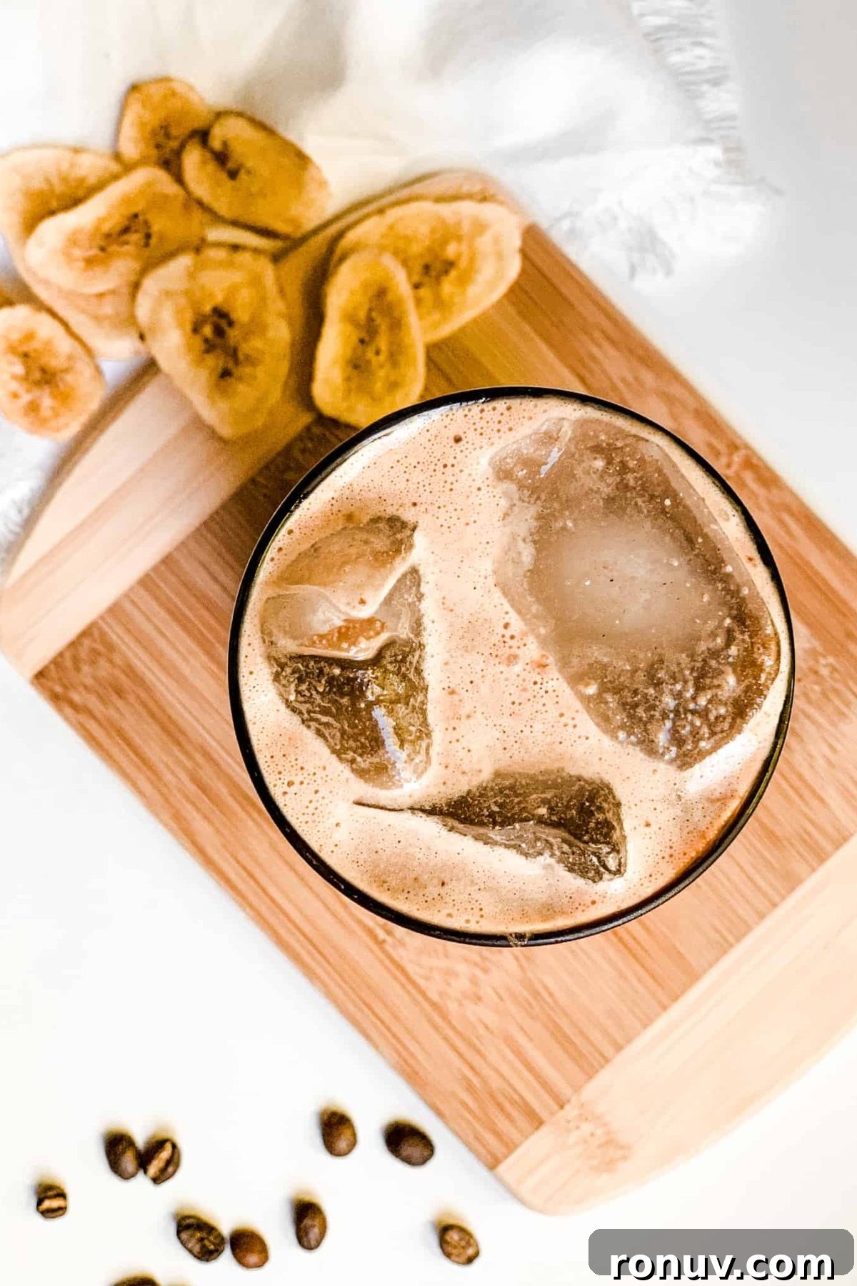 Creamy Iced Coffee Protein Smoothie Creamy Banana Coffee Smoothie in a Tall Glass with Coffee Beans and Sliced Bananas for Food Photography