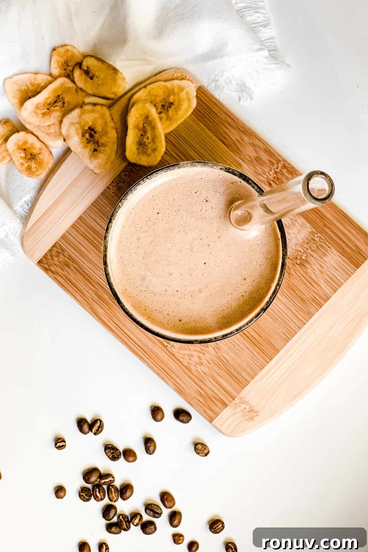 Iced Coffee Protein Smoothie with Banana Creamy Banana Coffee Smoothie in a Tall Glass with Coffee Beans and Sliced Bananas for Food Photography