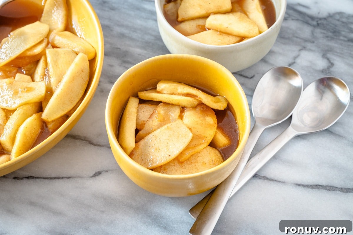 Warm Cinnamon-Baked Apples Recipe 2 Bowls of warm cinnamon apples with spoons.