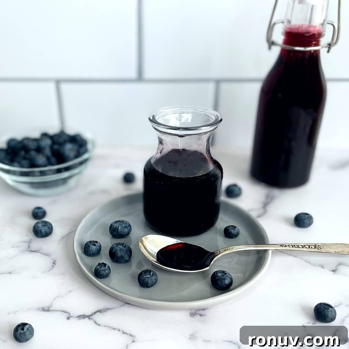 blueberry syrup in a jar and a bottle.