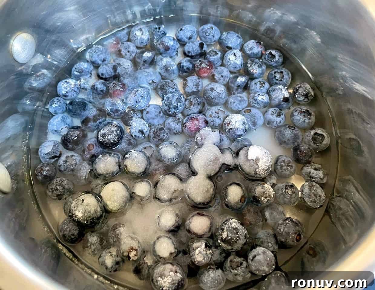 blueberries and sugar in a saucepan.