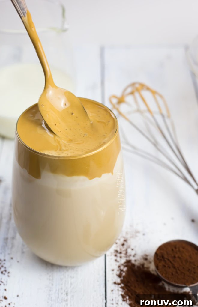 Dalgona Coffee Recipe: Whipped Coffee at Home 9 Stirring Dalgona coffee.
