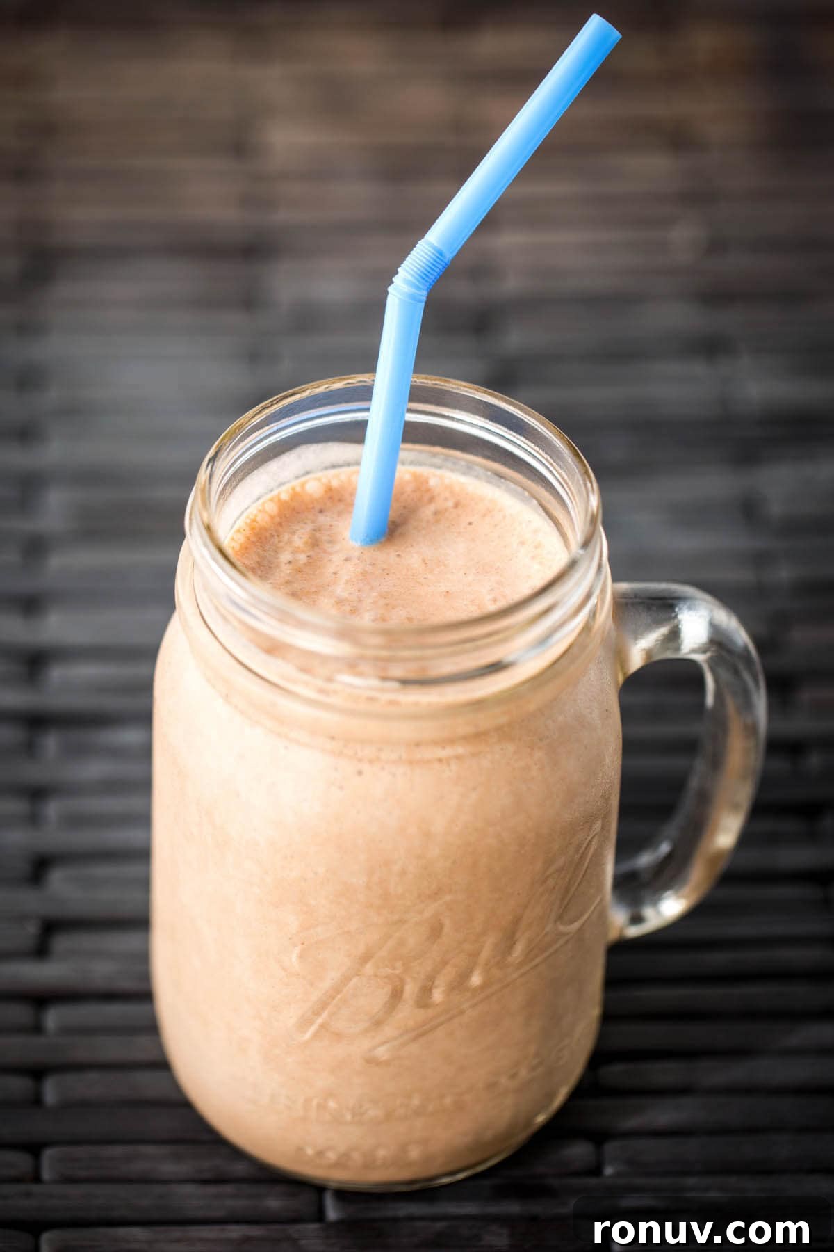 Creamy Chocolate Peanut Butter Banana Smoothie Recipe 2 Chocolate Peanut Butter Banana Smoothie in glass Ball jar with blue straw
