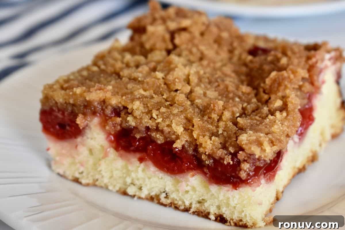 Make-Ahead Baby Shower Recipes and Party Food Ideas 11 Cherry Coffee Cake slice on a white plate.