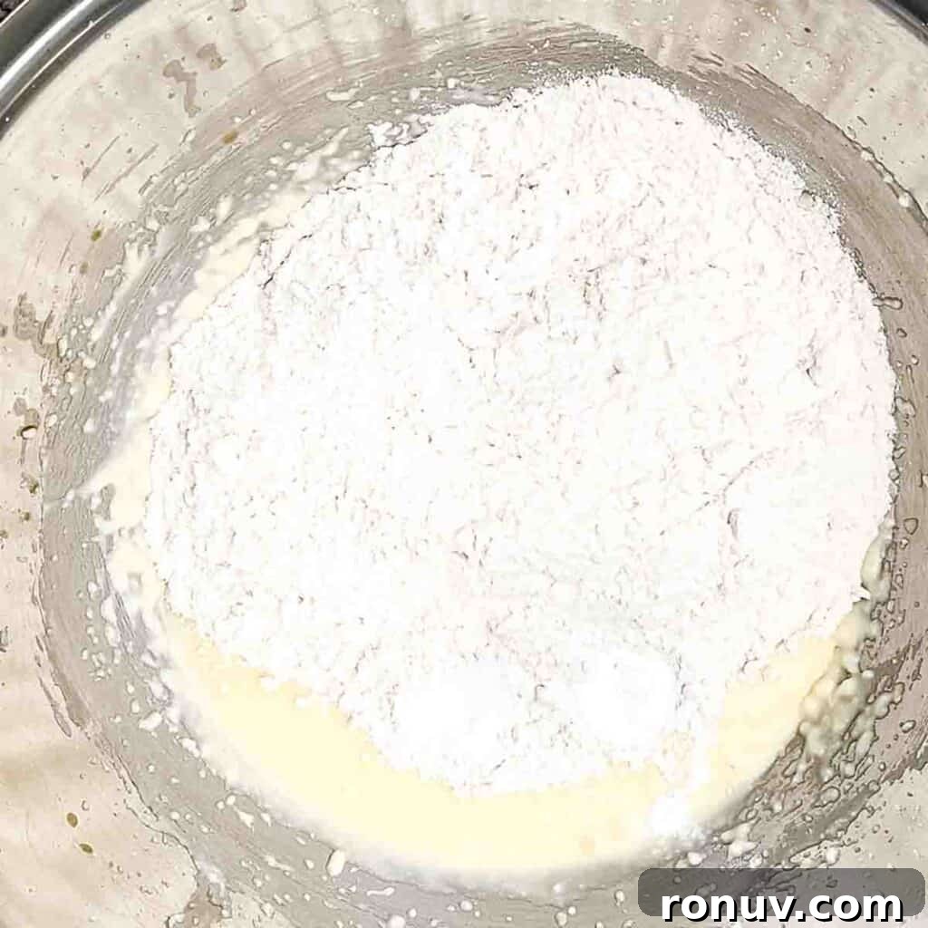 Air Fryer Sugar Cookies Recipe: Soft, Quick Homemade Treat 5 The flour added to the wet ingredients in the bowl.
