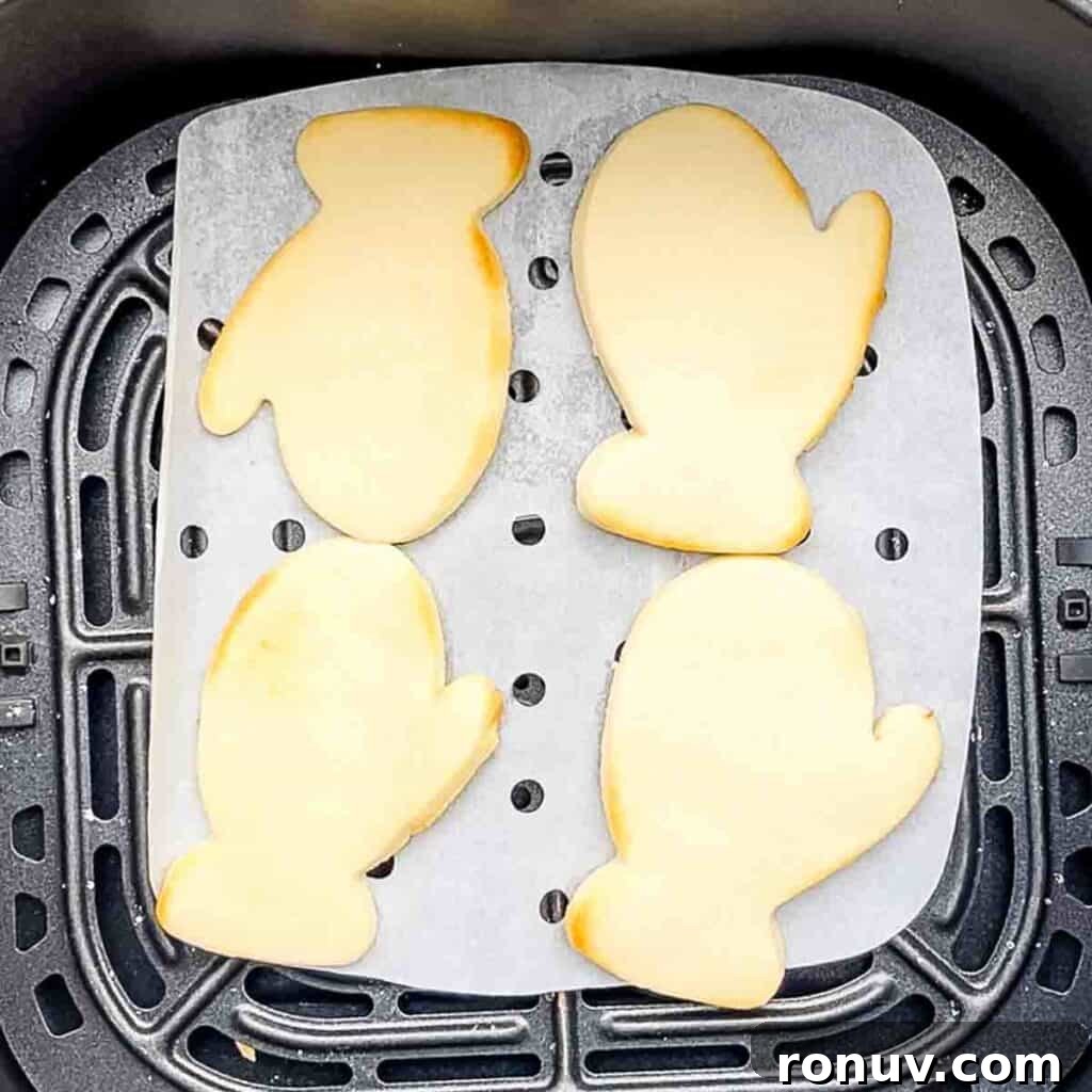 Air Fryer Sugar Cookies Recipe: Soft, Quick Homemade Treat 7 The sugar cookies fully cooked in the air fryer basket, with the outside edges slightly golden brown.