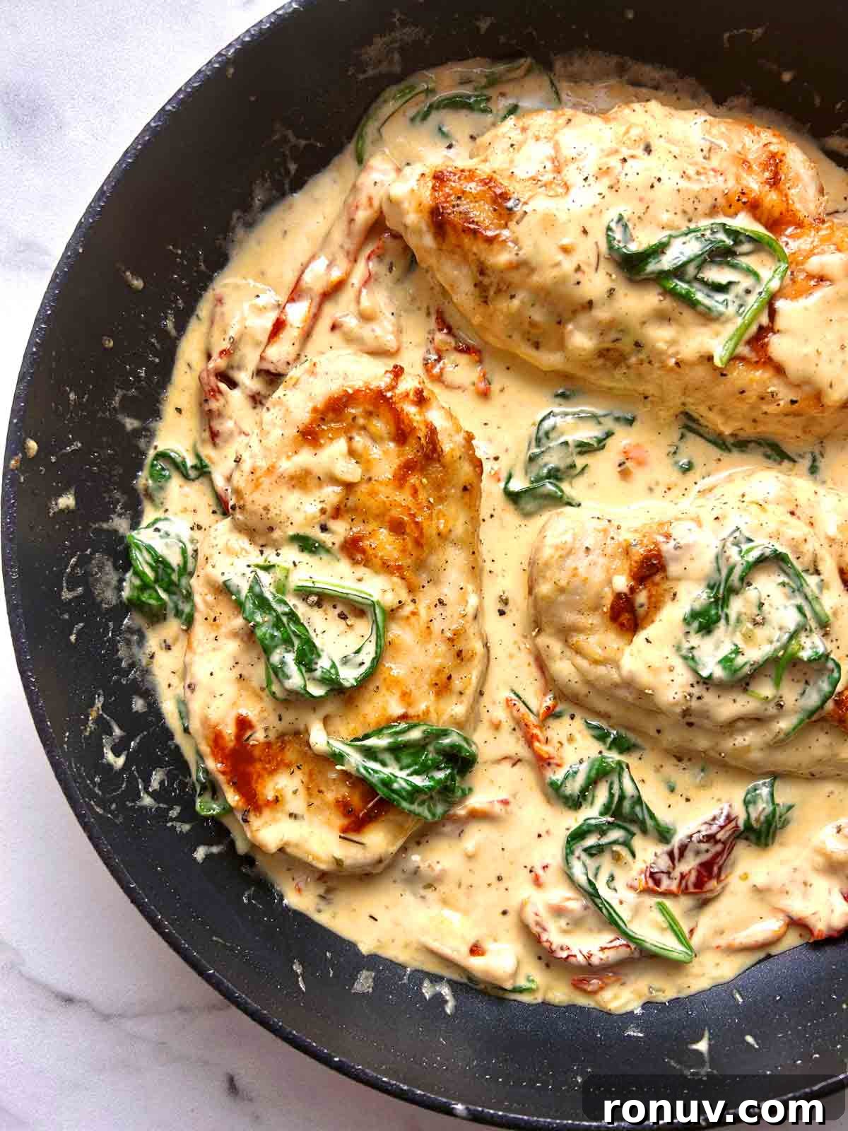 Creamy Tuscan Chicken Recipe with Spinach and Sun Dried Tomatoes 2 tuscan chicken in pan.