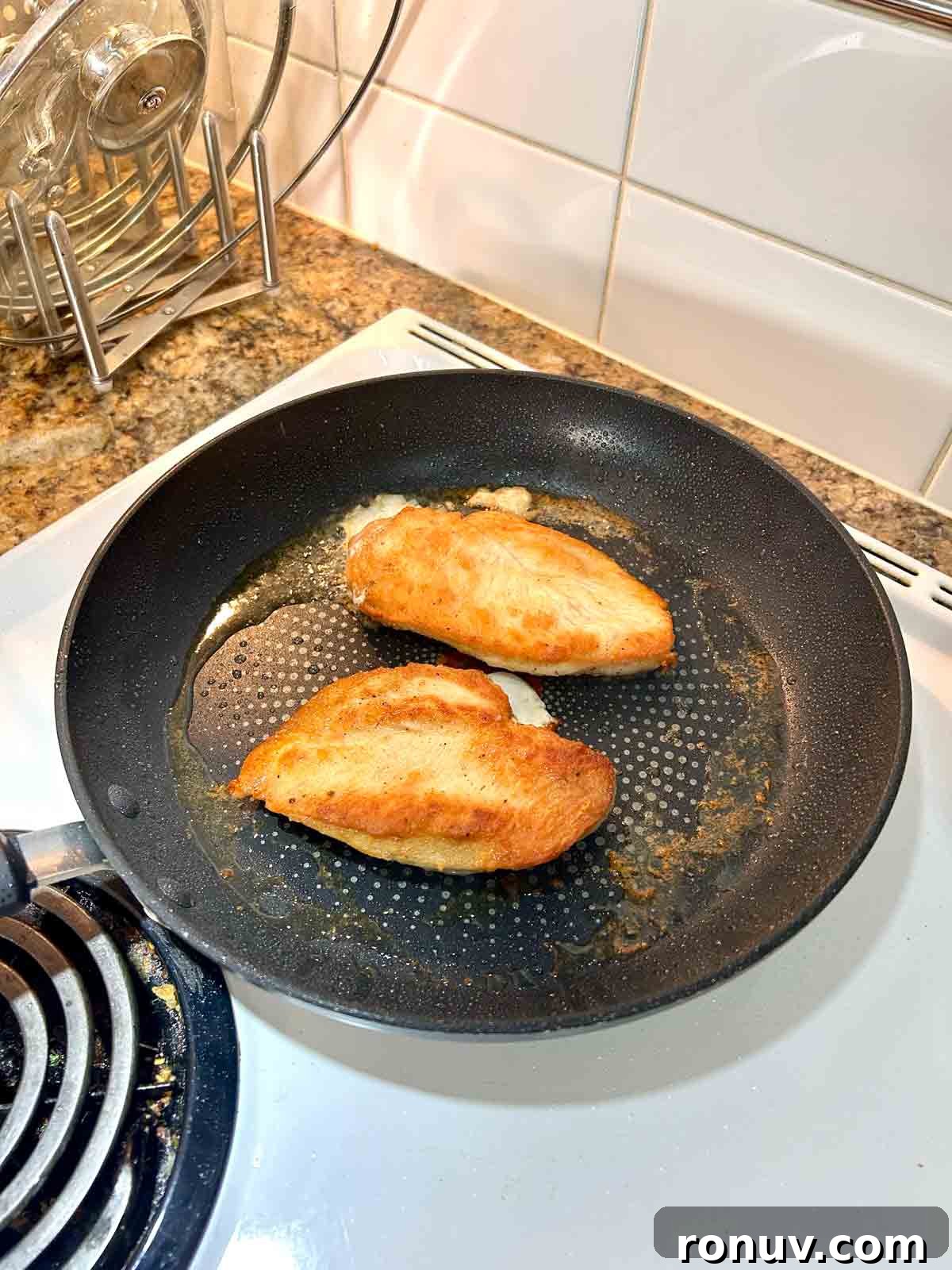 Creamy Tuscan Chicken Recipe with Spinach and Sun Dried Tomatoes 5 chicken being seared in pan.
