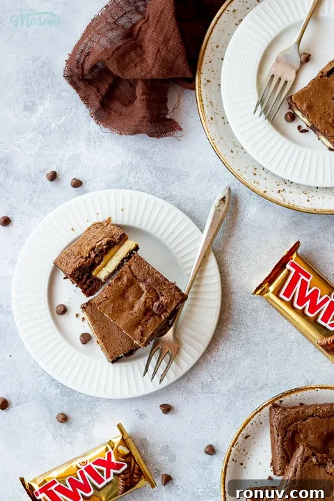 Homemade Fudgy Twix Brownies Recipe 17 Flat lay view of Twix brownies and a fork stacked on a plate.
