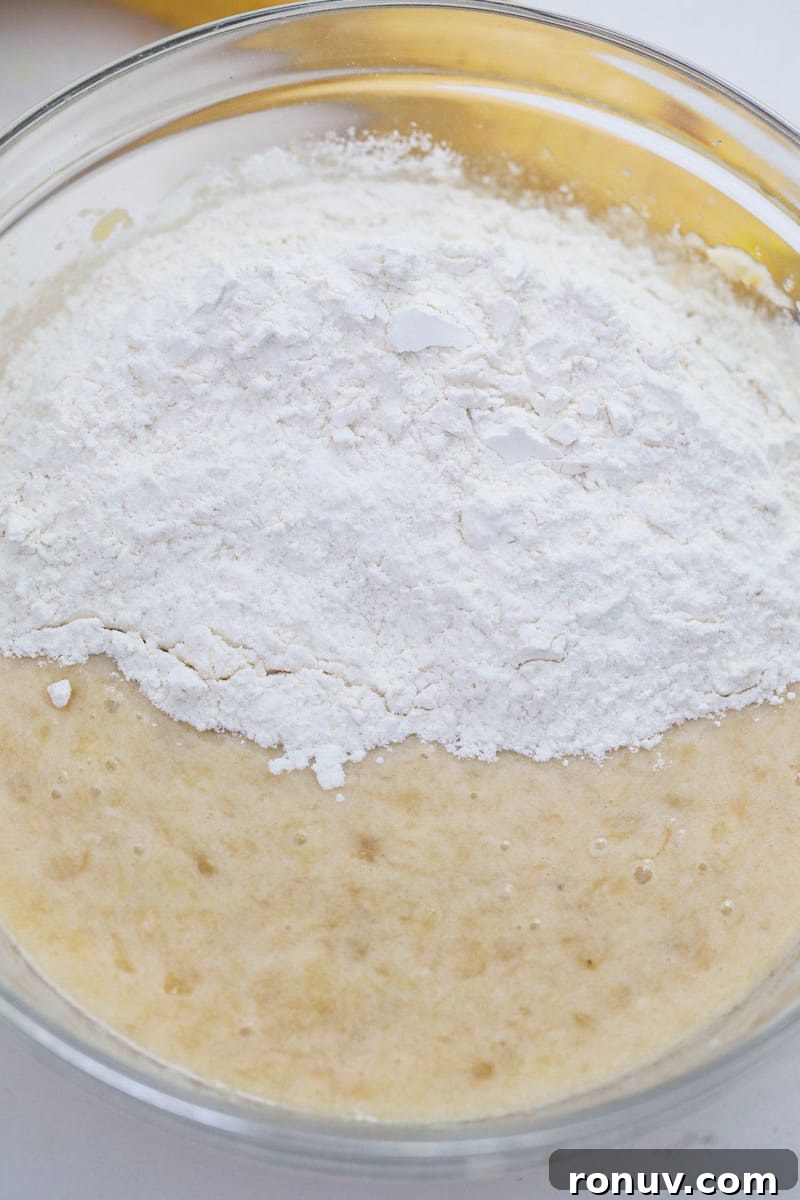 Moist Banana Nut Bread Recipe with Walnuts 5 mixing together wet and dry ingredients for banana nut bread