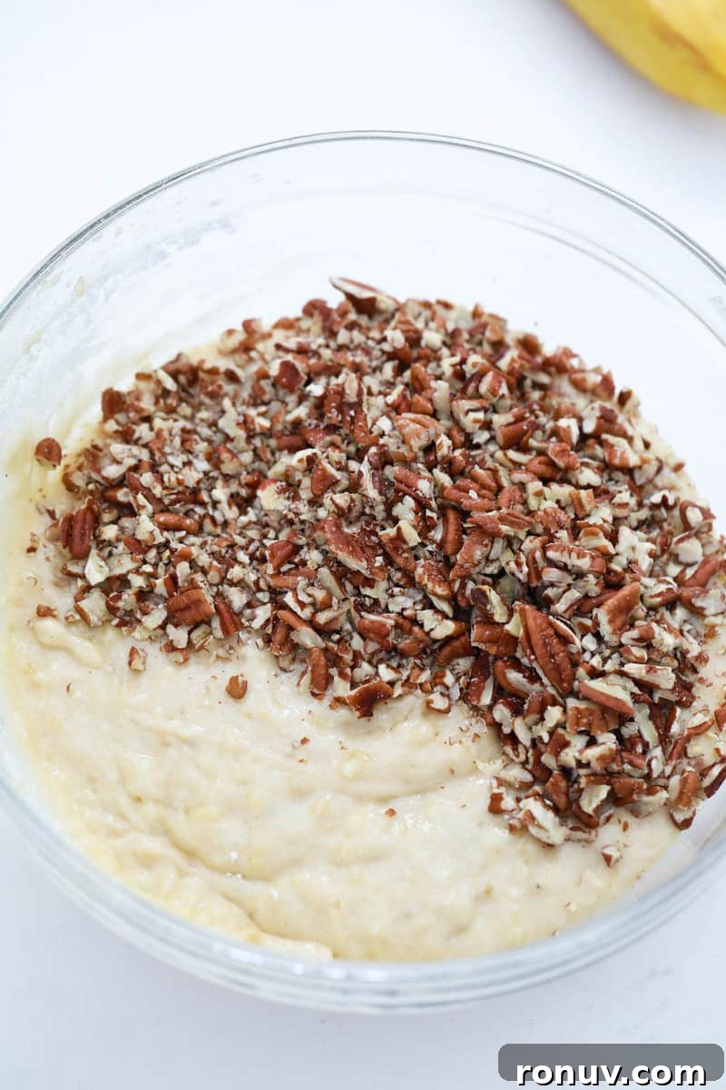 Moist Banana Nut Bread Recipe with Walnuts 6 adding in the pecans