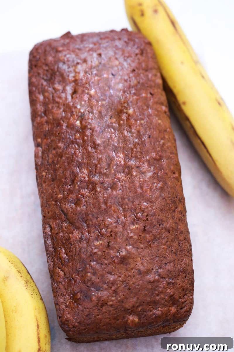 Moist Banana Nut Bread Recipe with Walnuts 7 banana nut bread on countertop with bananas in background