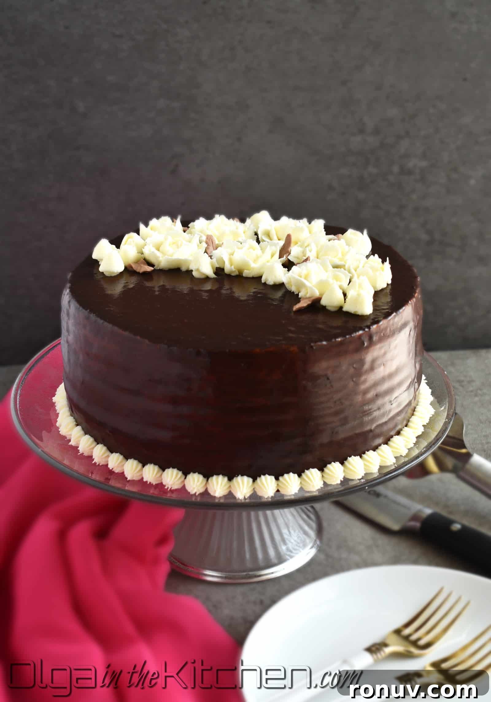 Layered Russian Chocolate Spartak Cake Recipe 2 Chocolate Spartak Cake: chocolate-y, 9-layer cake, filled with sour cream frosting, topped with chocolate ganache and decorated with buttercream flowers! | olgainthekitchen.com