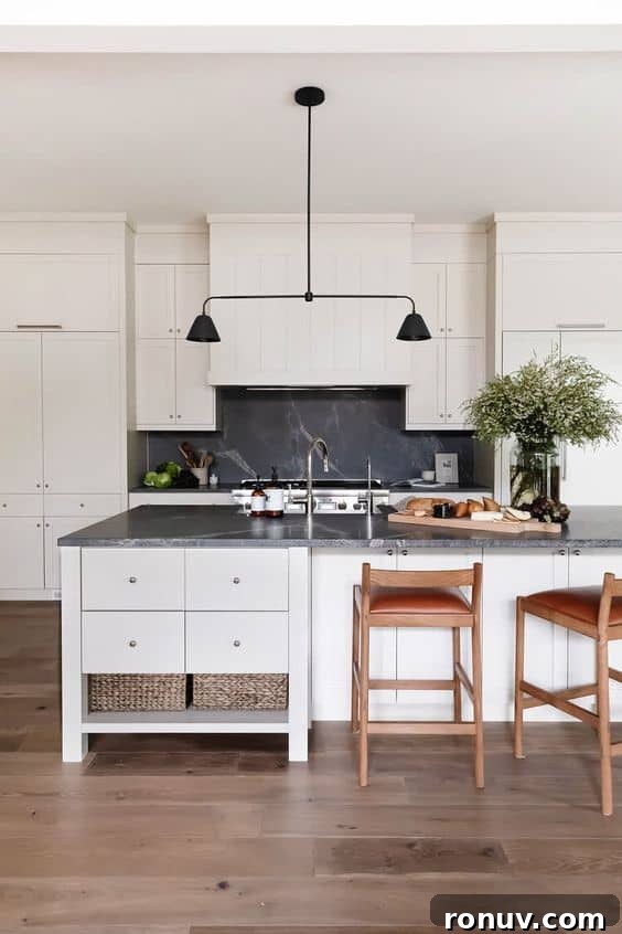 Granite Countertops: Pros, Cons, and Cost Guide 4 white kitchen with dark grey and white veined granite countertops with a black pendant light above the island