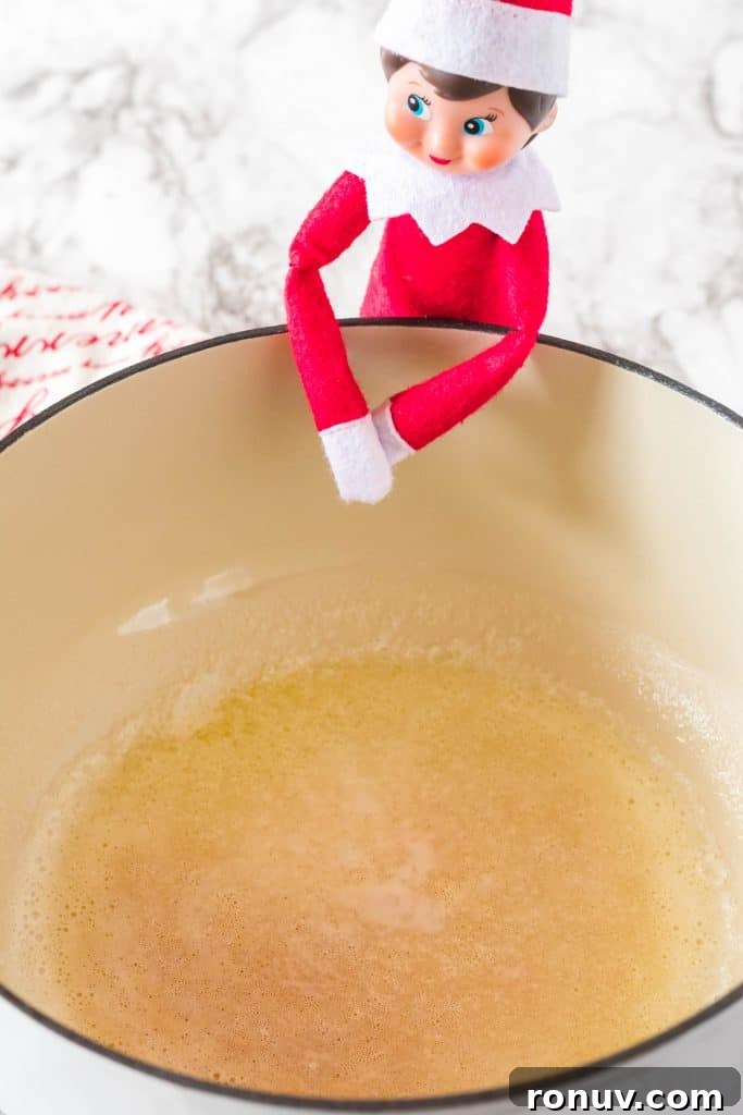 Elf on the Shelf Rice Krispie Treat Recipe for Christmas 5 elf on the shelf leaning over a bowl