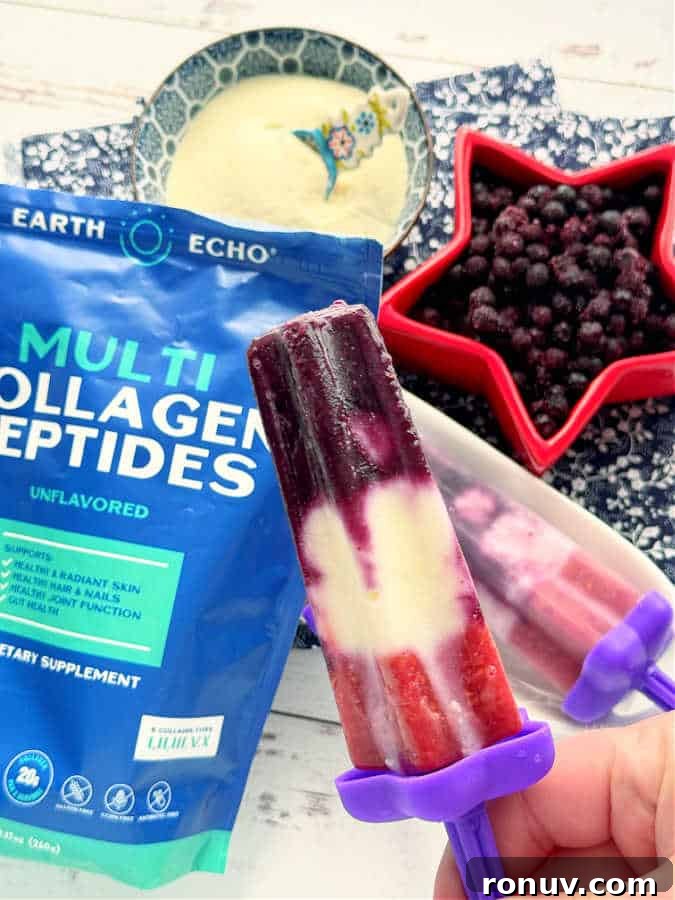 Homemade Collagen Popsicles Recipe for Glowing Skin 2 a red white and blue collagen popsicle ready to eat - it includes Earth Echo brand multi collagen peptides mixed with frozen blueberries, raspberries and vanilla Greek yogurt