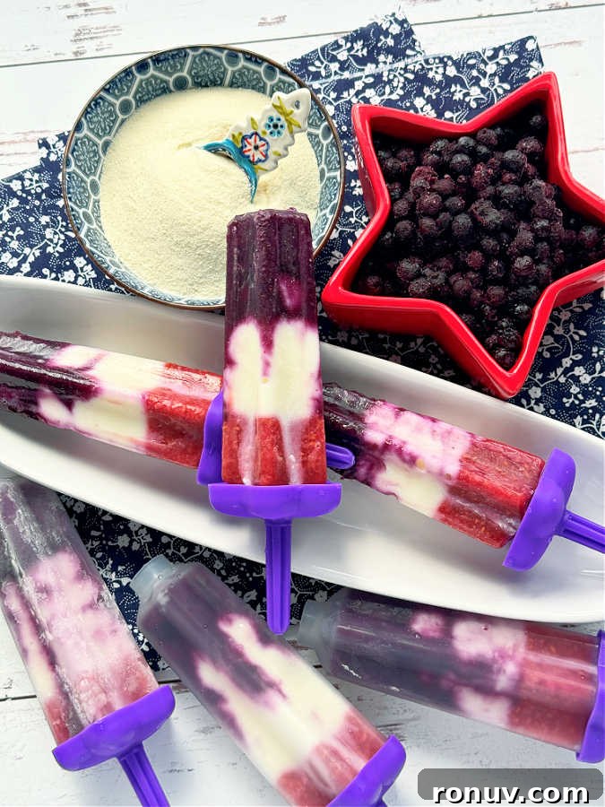 Homemade Collagen Popsicles Recipe for Glowing Skin 4 a display of all the red white and blue collagen popsicles, three ready to eat and three still in the popsicle molds