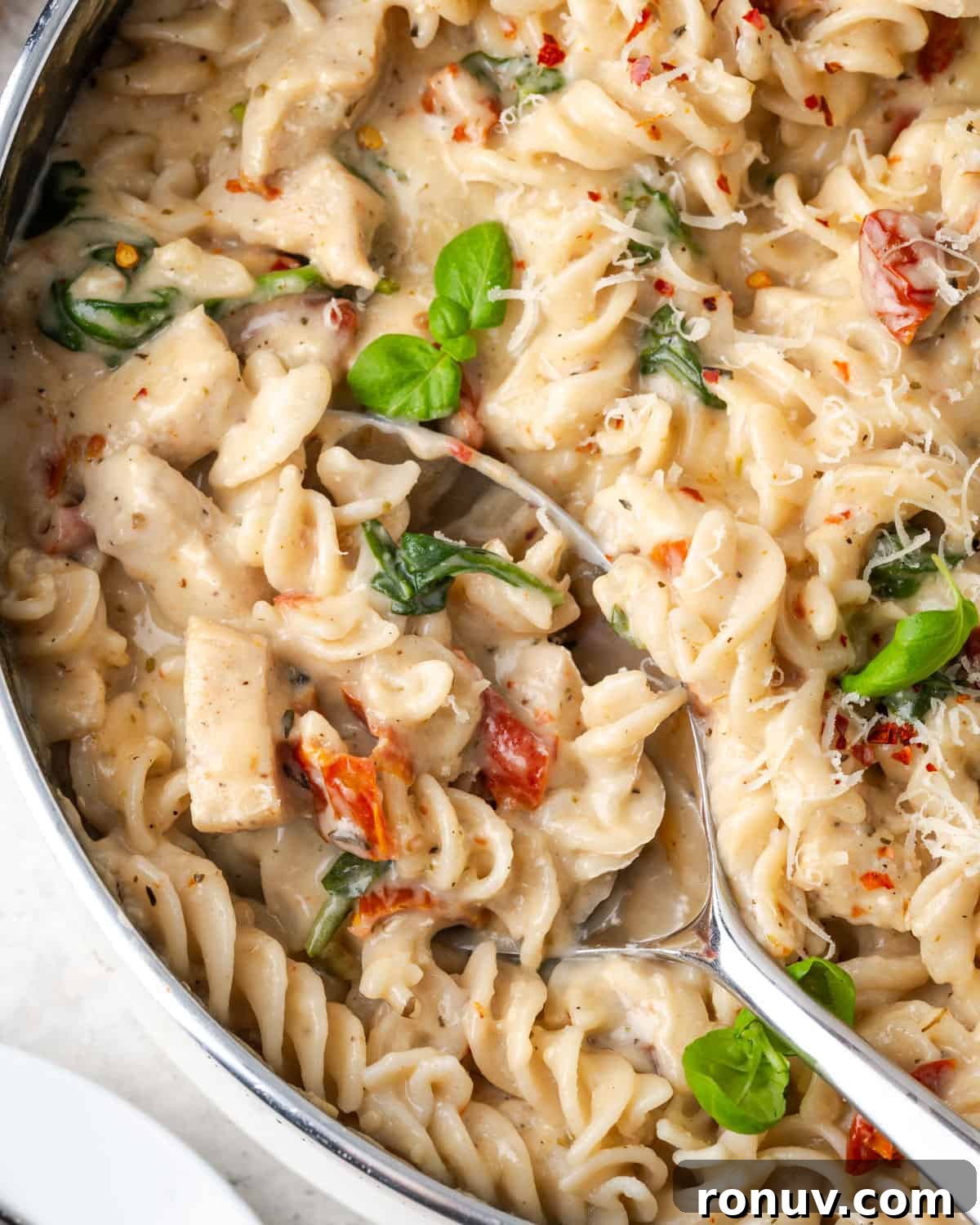 30-Minute Creamy Marry Me Chicken Pasta Recipe 2 A spoon scooping out a portion of marry me chicken pasta.