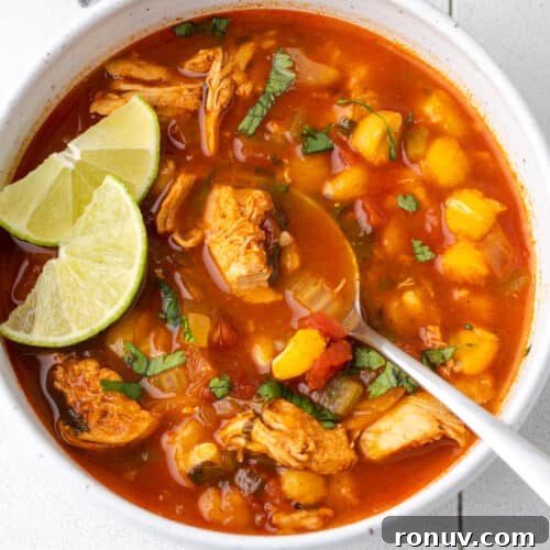 30-Minute Creamy Marry Me Chicken Pasta Recipe 16 A bowl of chilis southwest chicken soup topped with cilantro and lime slices.