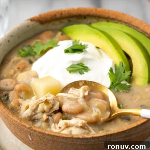 30-Minute Creamy Marry Me Chicken Pasta Recipe 17 A bowl of white chicken chili topped with sour cream and sliced avocado.