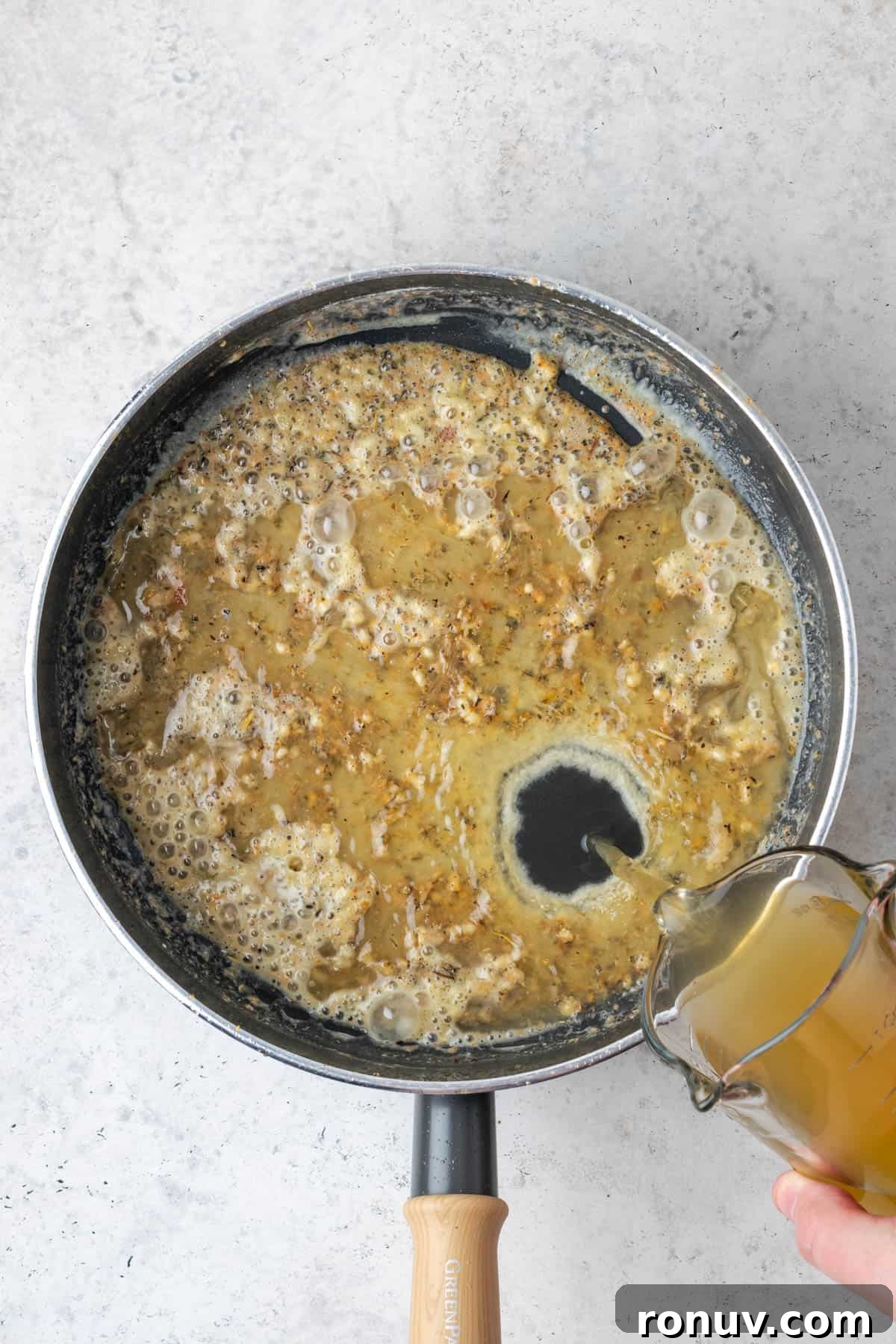 30-Minute Creamy Marry Me Chicken Pasta Recipe 9 Chicken broth being poured into the saute pan with the roux.