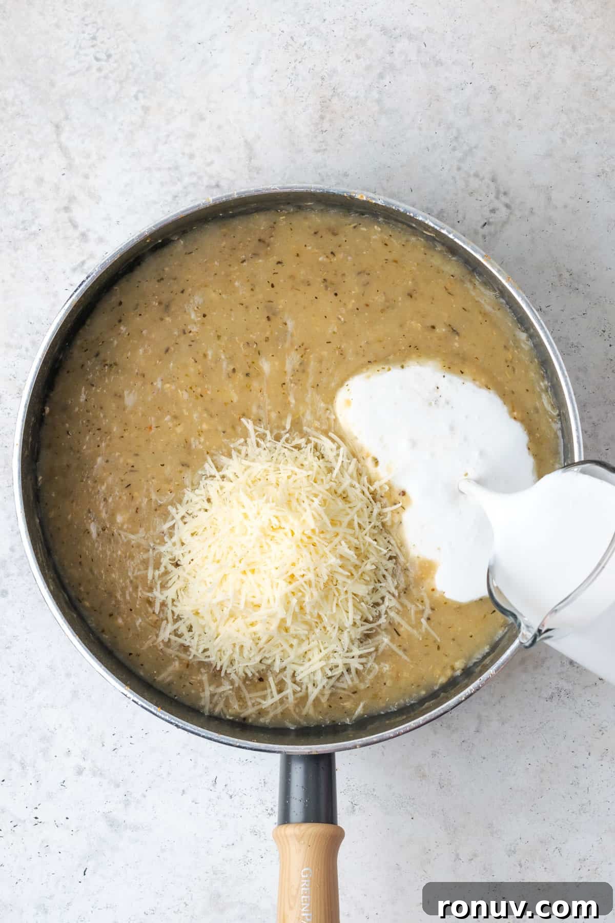 30-Minute Creamy Marry Me Chicken Pasta Recipe 10 Parmesan cheese and cream being added to the garlic sauce.