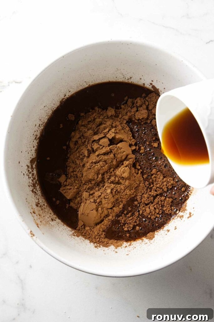 Triple Chocolate Layer Cake Recipe: Moist, Fudgy Layers 4 Pouring hot coffee into a bowl with unsweetened cocoa powder.