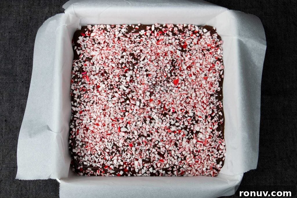 No-Bake Chocolate Peppermint Fudge Recipe 4 Peppermint fudge in a lined baking pan.
