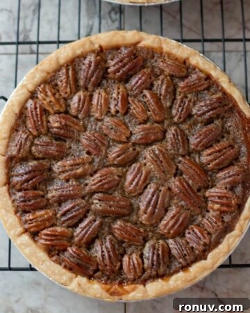 No-Bake Peanut Butter Caramel Cheesecake Pie Recipe 5 A homemade pecan pie on a wire rack cooling.