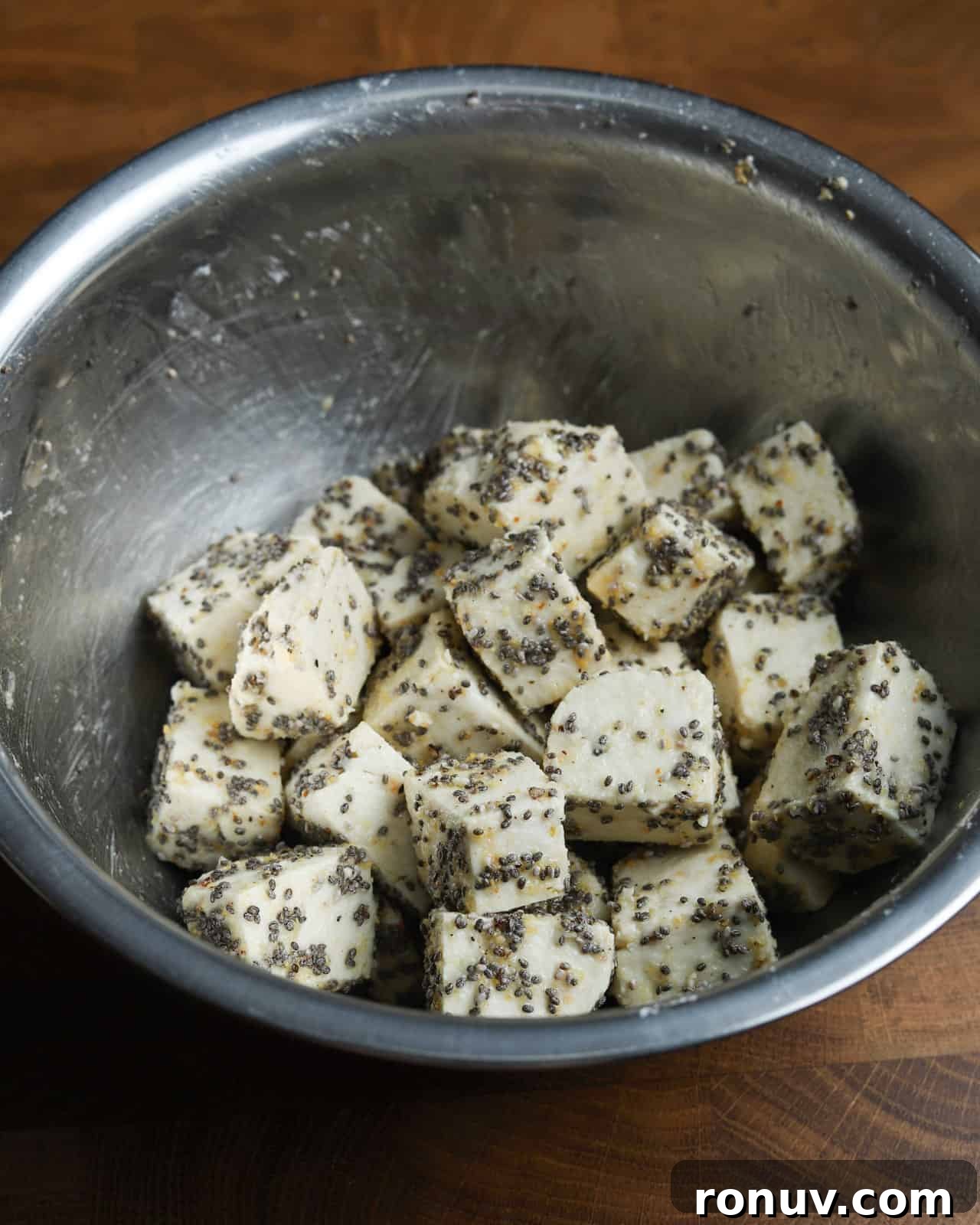 Crispy Air Fryer Tofu Recipe with Chia Seeds 6 image showing a metal bowl with the crispy chia tofu ingredients mixed together waiting to be cooked.