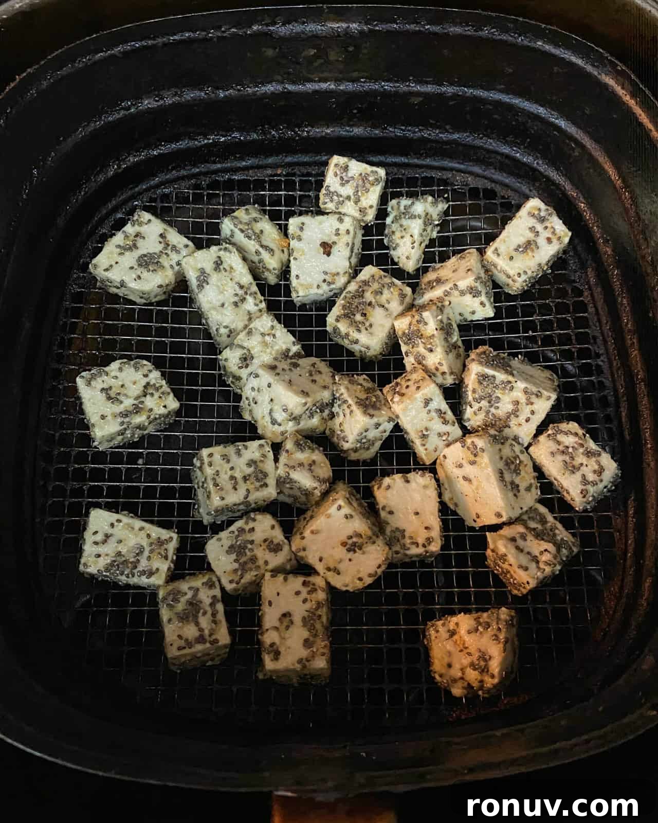 Crispy Air Fryer Tofu Recipe with Chia Seeds 7 Image showing crispy chia tofu cubes in the air fryer basket.