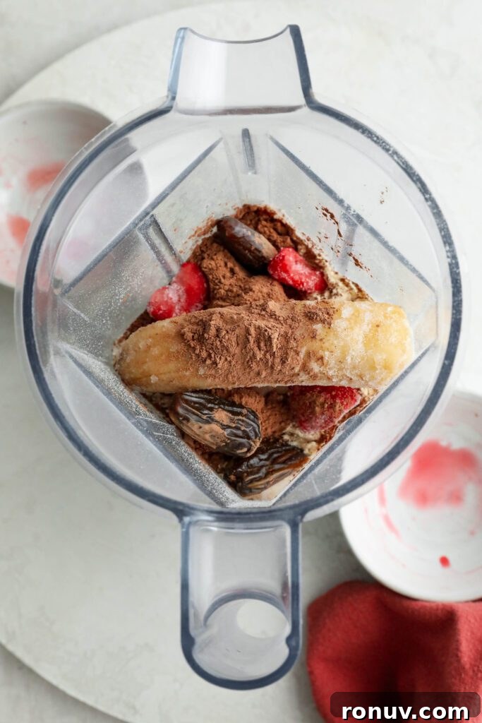 Creamy Red Velvet Protein Shake Recipe 5 Red Velvet Protein Shake ingredients in blender with red towel by Flora & Vino