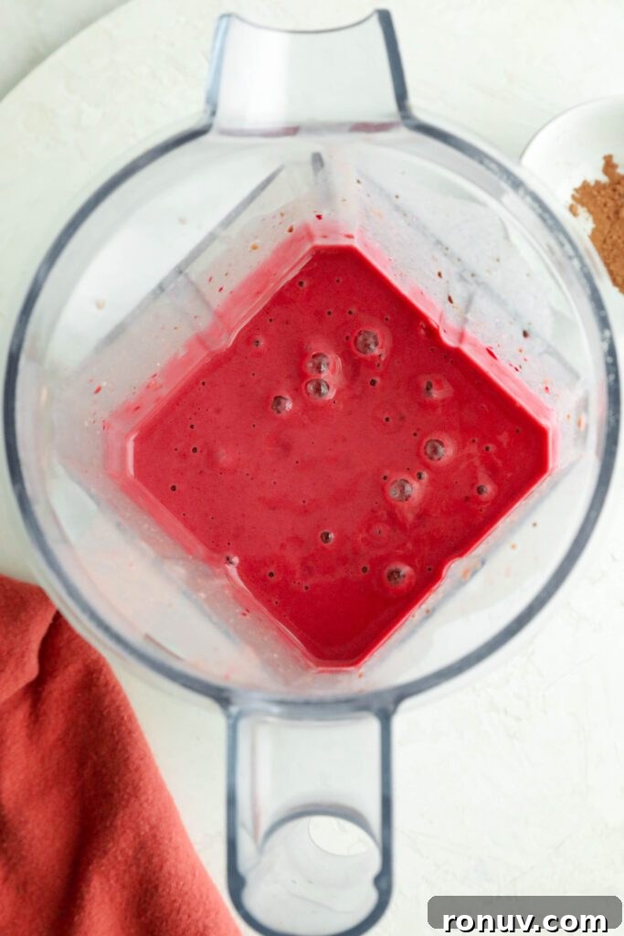 Creamy Red Velvet Protein Shake Recipe 6 Red Velvet Protein Shake blended in Vitamix with red towel by Flora & Vino