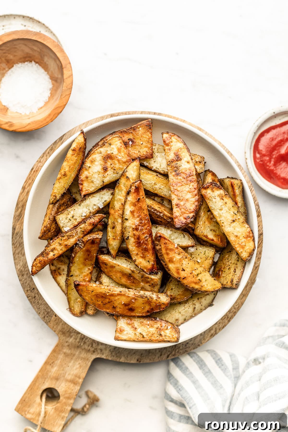 Crispy Oven-Roasted Potato Wedges with Garlic 4 Close up of golden roasted potato wedges