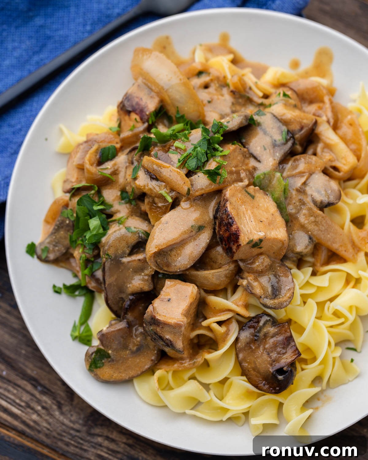 Creamy Chicken Stroganoff with Mushrooms and Egg Noodles 6 White plate with chicken stroganoff over egg noodles.