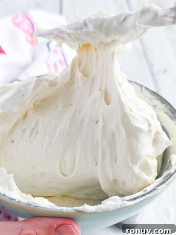 Bowl of cool whip frosting with a knife.