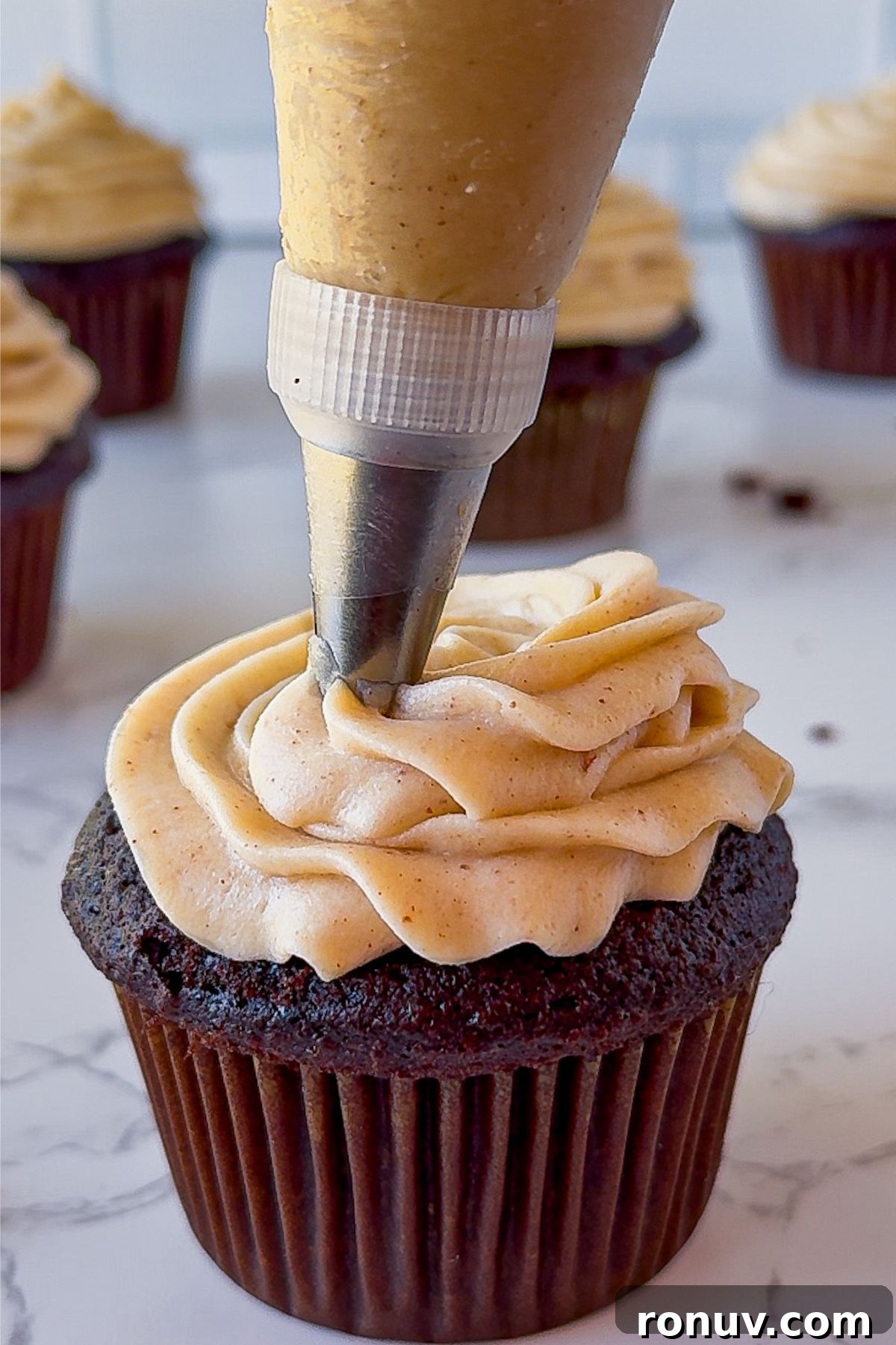 Brown Butter Cream Cheese Frosting on a cupcake.