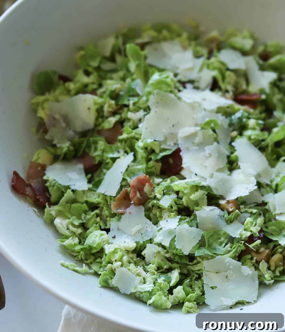 Shaved Brussels Sprouts Salad with Crispy Bacon 8 Brussel sprout salad in bowl.