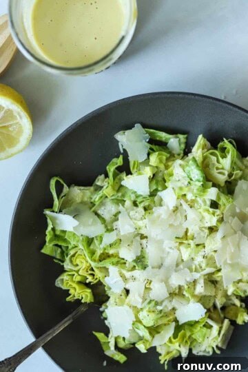 Caesar salad topped with caesar dressing with no anchovies in bowl.