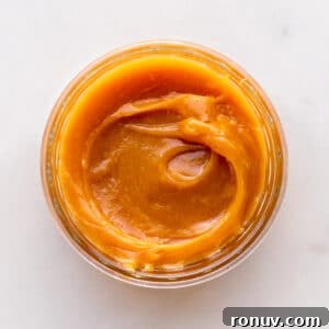 How to Make Dulce de Leche at Home 7 A jar of homemade milk jam viewed from the top to show the gooey, thick texture.