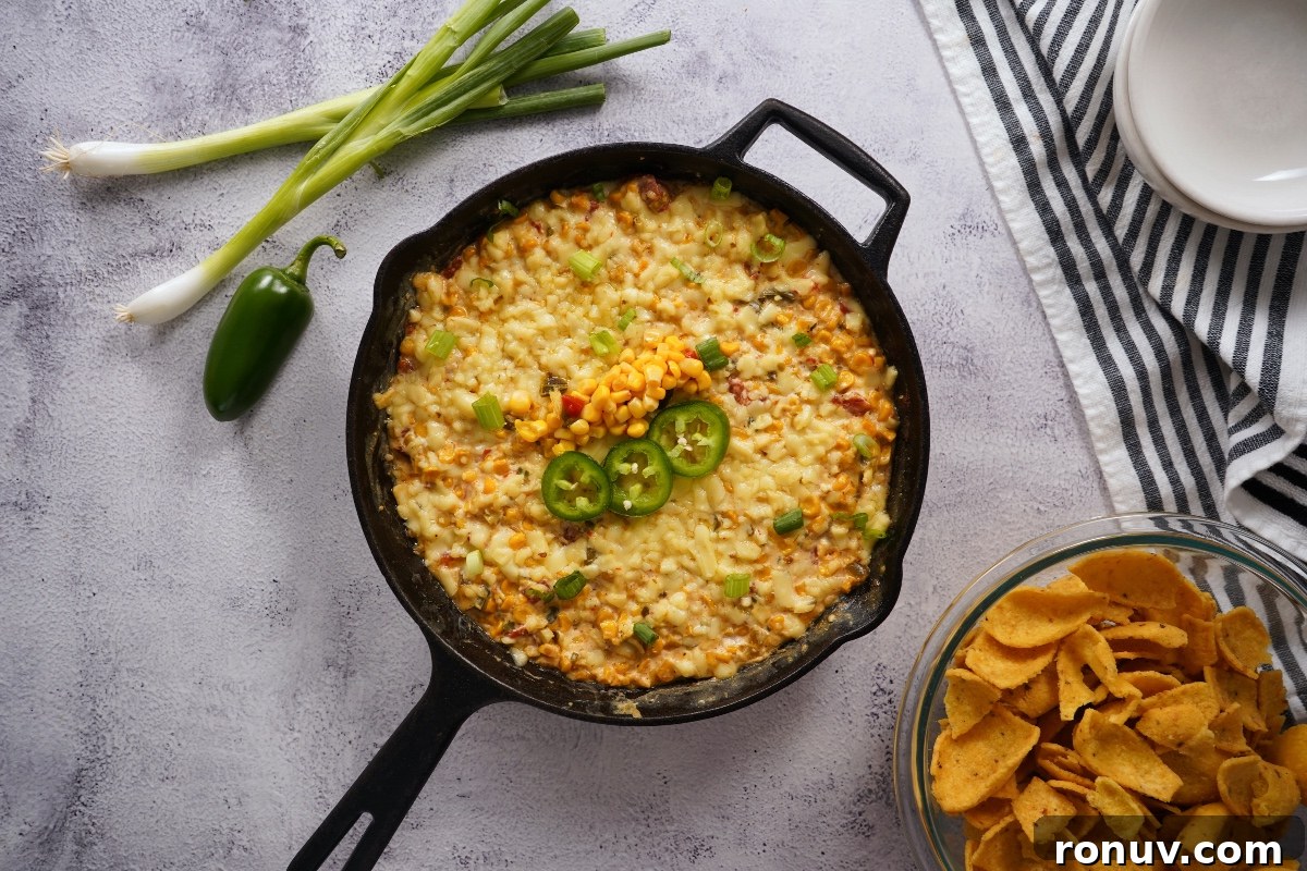 Smoky Jalapeno Corn Dip Recipe 2 smoked corn dip in cast iron pan with corn chips in bowl
