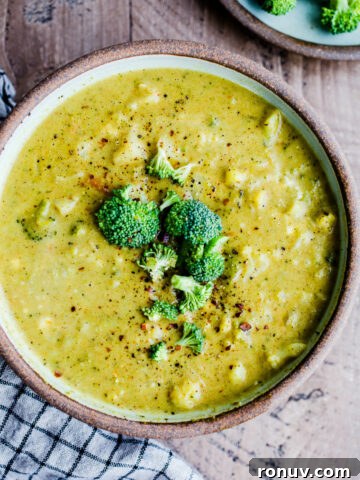 Curried broccoli cauliflower soup in a rustic bowl.