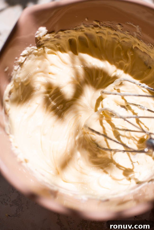 Gooey Caramel Apple Butter Cake Recipe 9 Mixing cream cheese filling