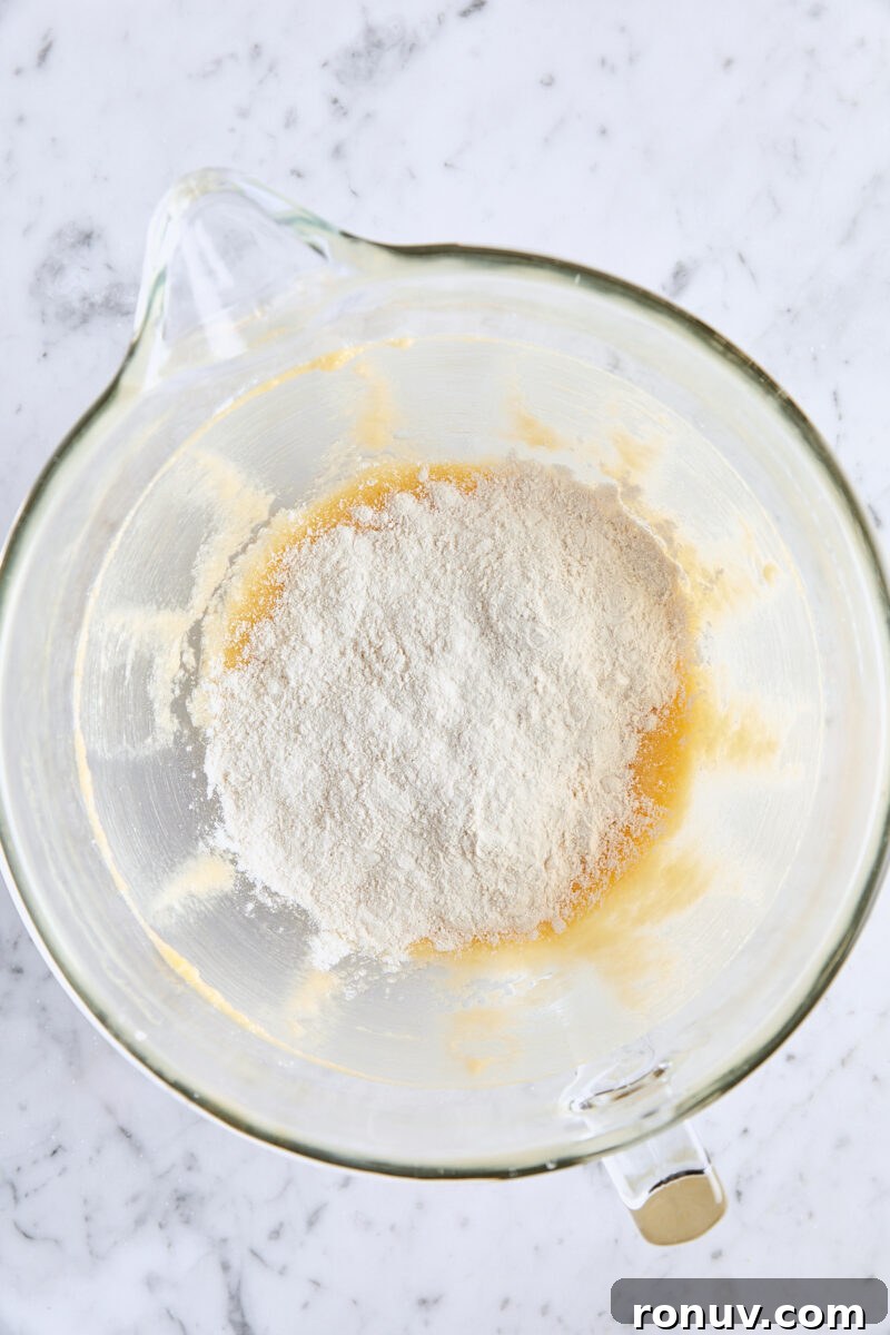 Moist Sour Cream Coffee Cake Recipe with Cinnamon Streusel 6 Dry ingredients added to batter in glass mixing bowl