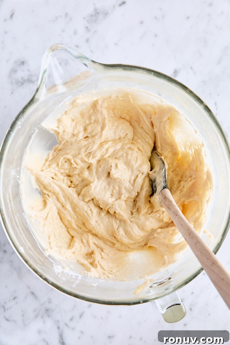 Moist Sour Cream Coffee Cake Recipe with Cinnamon Streusel 7 Sour cream coffee cake batter in glass mixing bowl with spatula